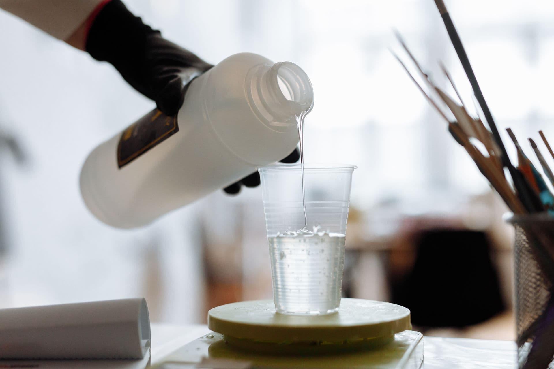 Styrene acrylic emulsion poured into a lab sample beaker