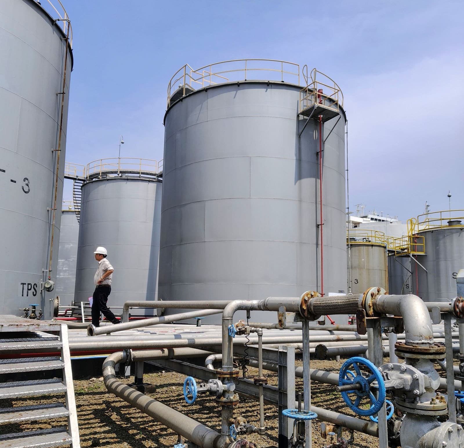 Engineer walking between polymer storage tanks at TAFAUL's Jeddah plant