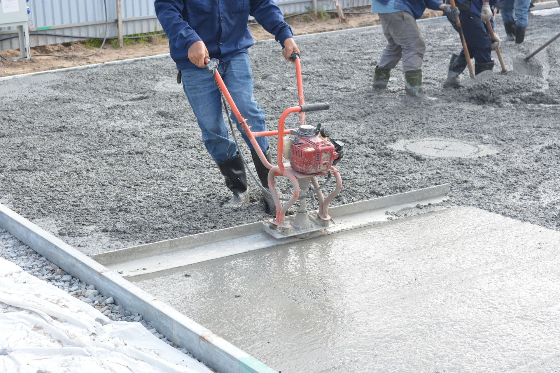 Worker applying polymer-modified mortar