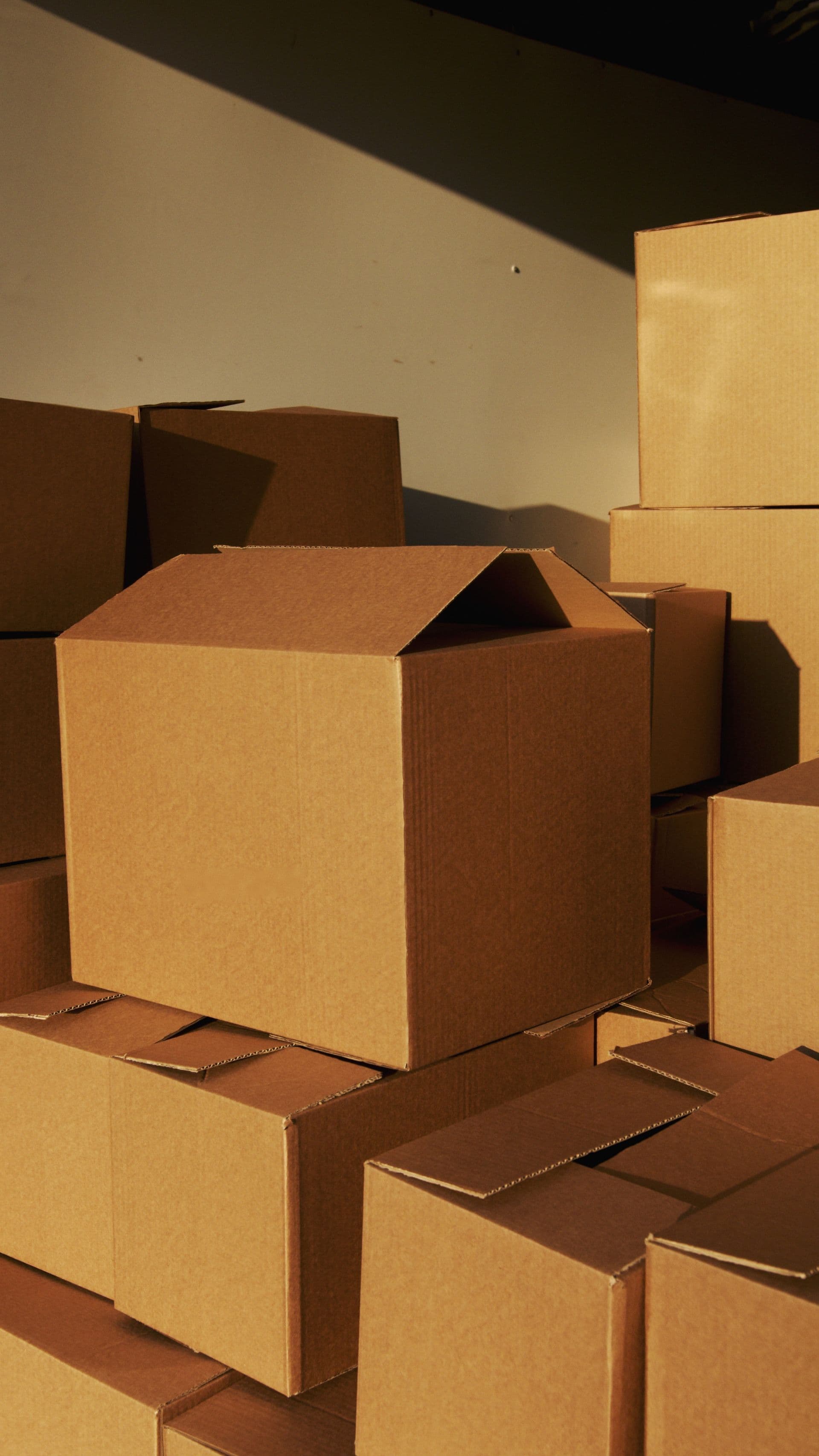 Cardboard packaging boxes laminated with adhesive systems